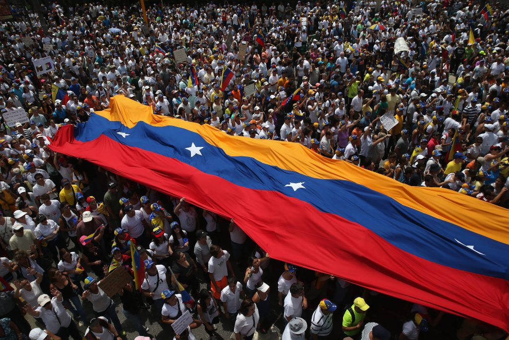 CARACAS, VENEZUELA - MARCH 02:  Thousands of protesters march in one of the largest anti-government demonstrations yet on March 2, 2014 in Caracas, Venezuela. Venezuela has one of the highest inflation rates in the world, and opposition supporters have protested for almost three weeks, virtually paralyzing business in much of the country.  (Photo by John Moore/Getty Images)